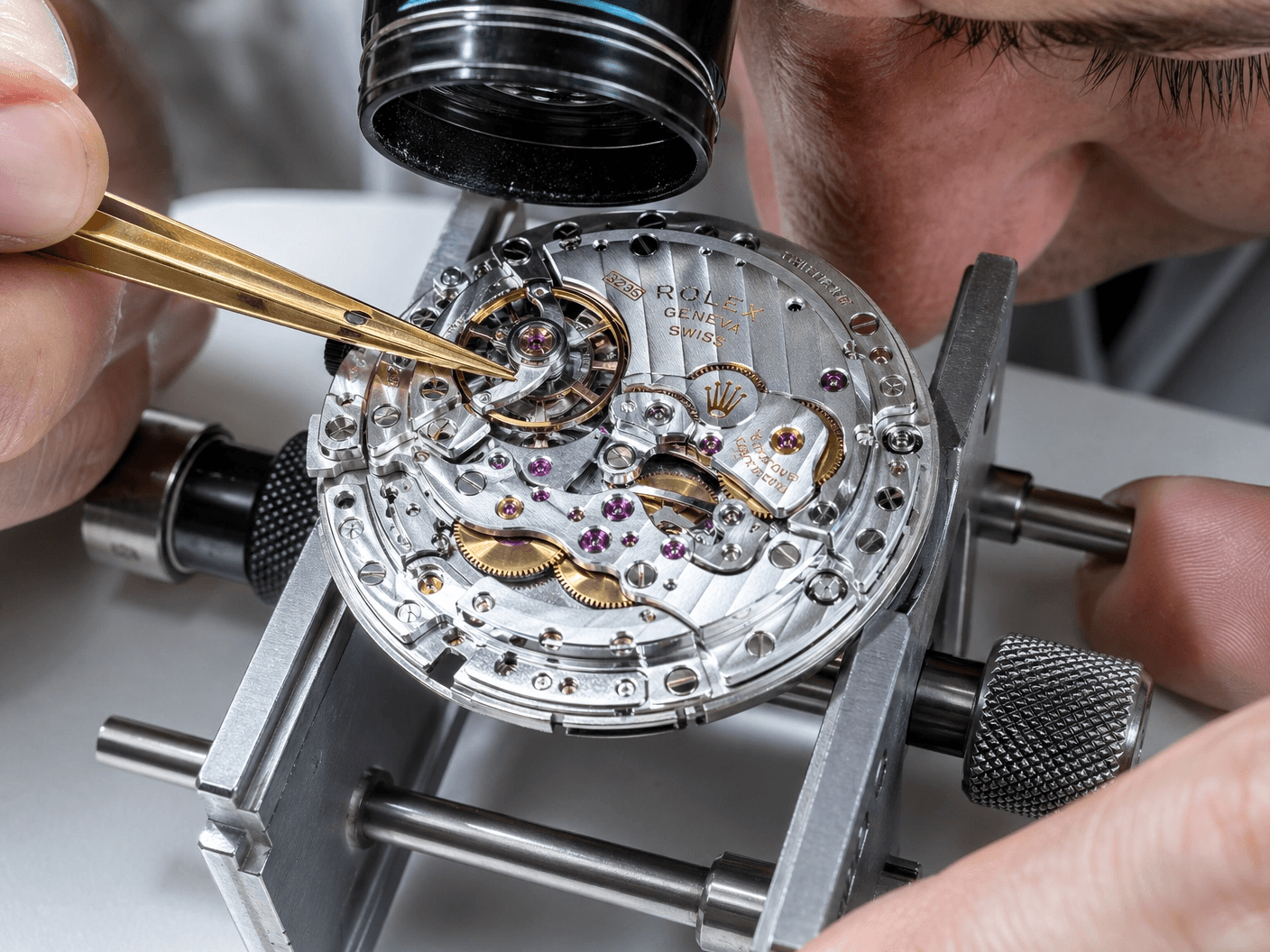 A watchmaker inspecting a Rolex movement during Crown Watch Group's multi-point authentication